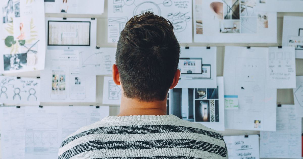 A man looking at a vision board