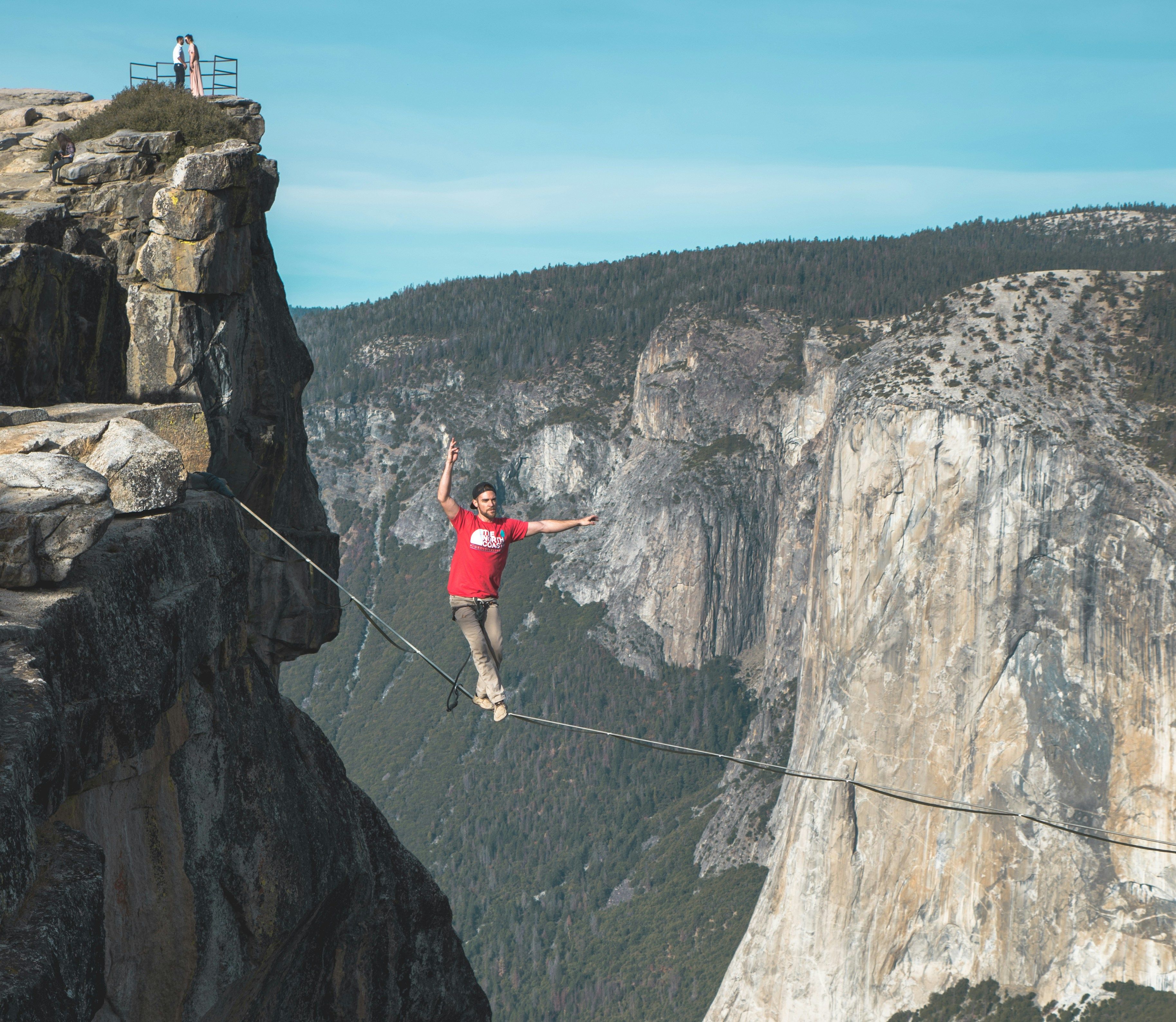 A man walking a tightrope risking falling