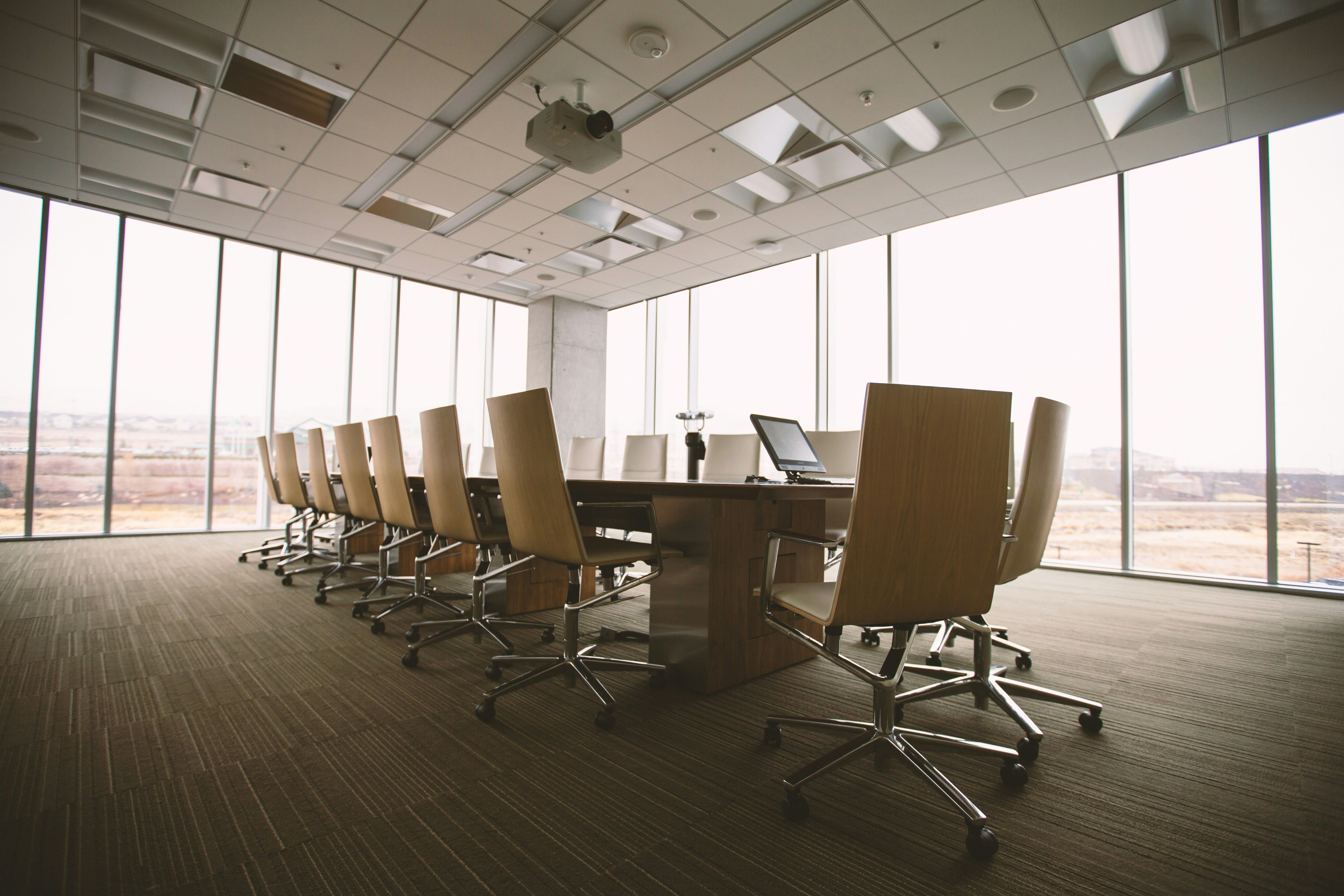 A meeting room with a table and chairs