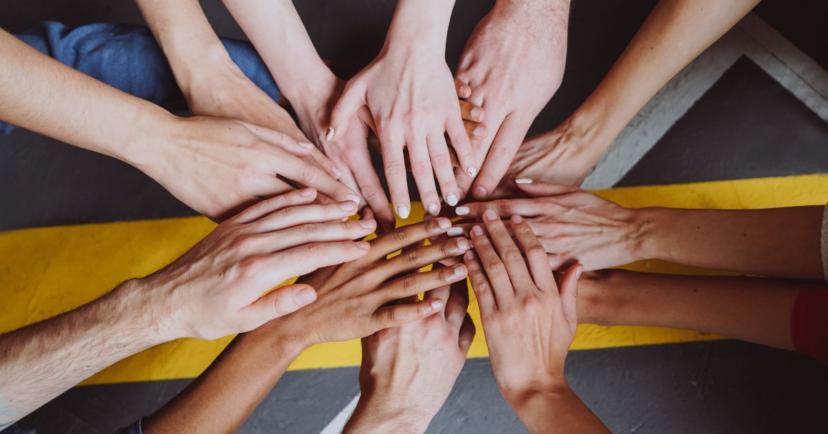 Hands stacked on top of each in unity