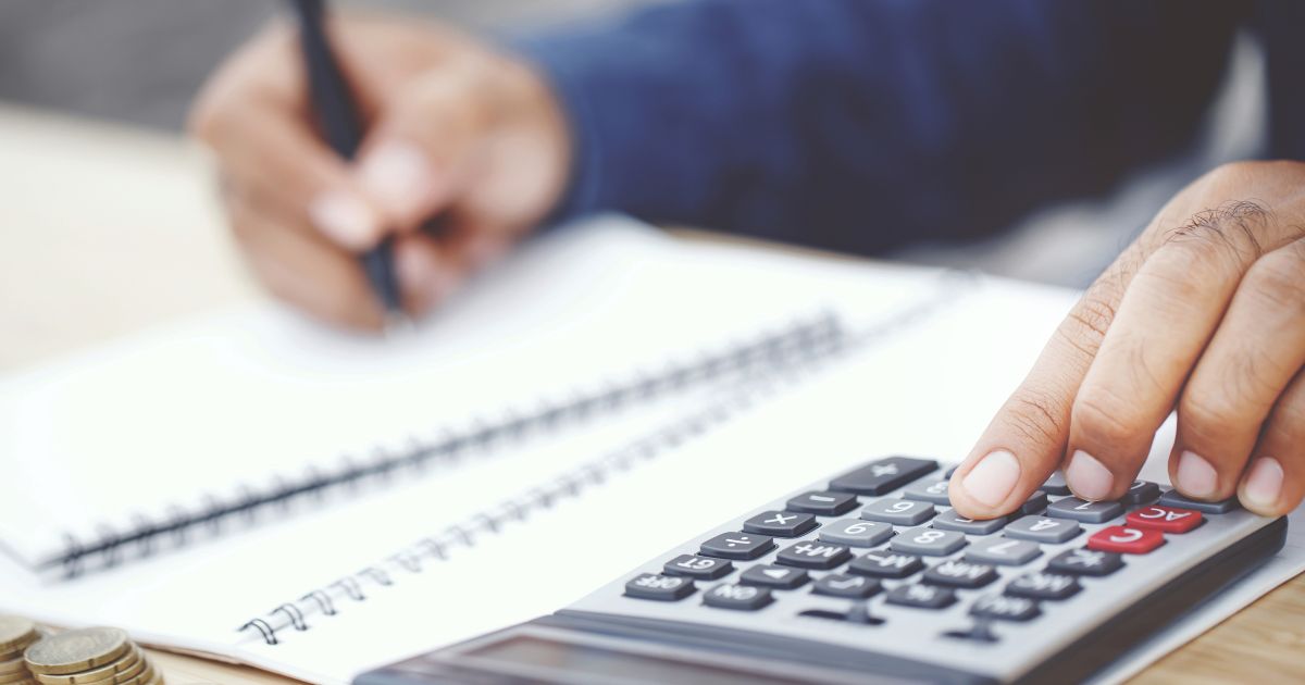 A man making calculations on a calculator