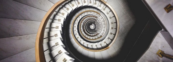 A close view of a spiral staircase with a circular shape and geometric pattern