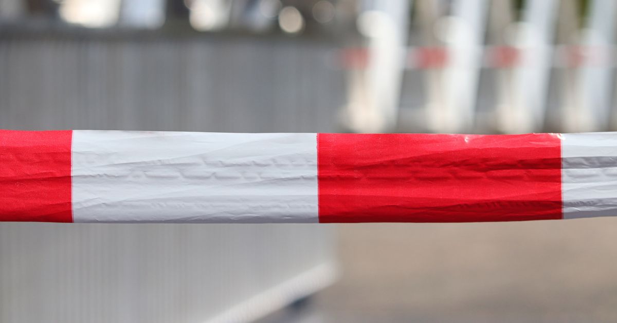 A red and white barrier blocking entry