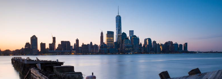 Manhattan skyline at dusk as seen from the shore