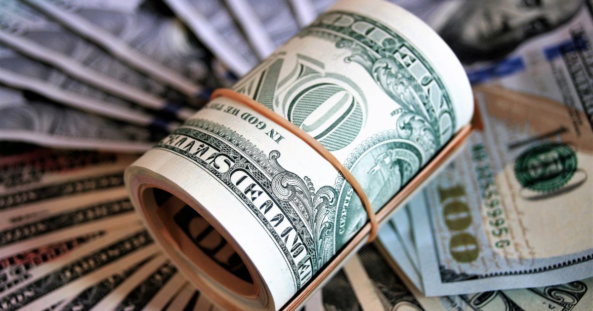 Roll of Dollar bills tied with an elastic band